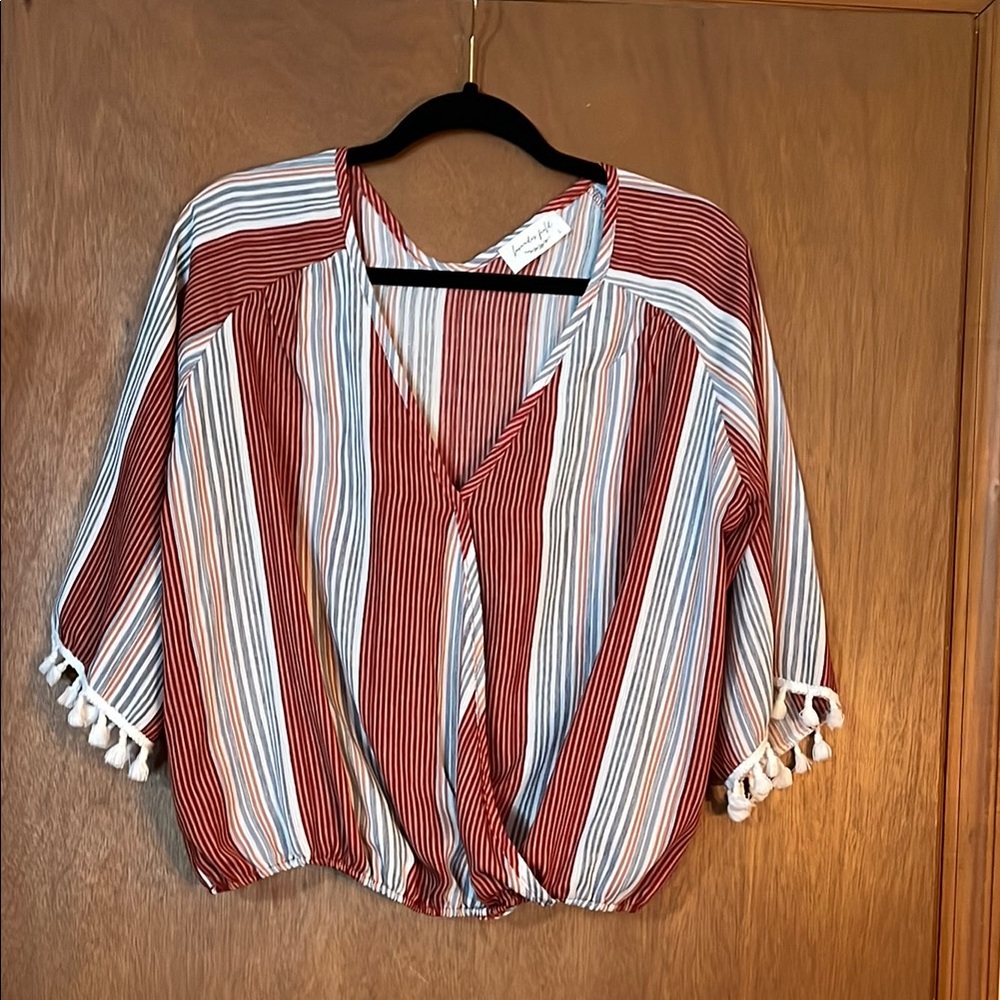 Super fun V-neck top with gathered bottom and tasseled sleeves